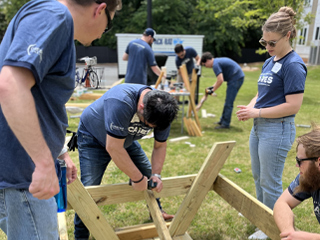 Crescent employees making a bench and picnic table